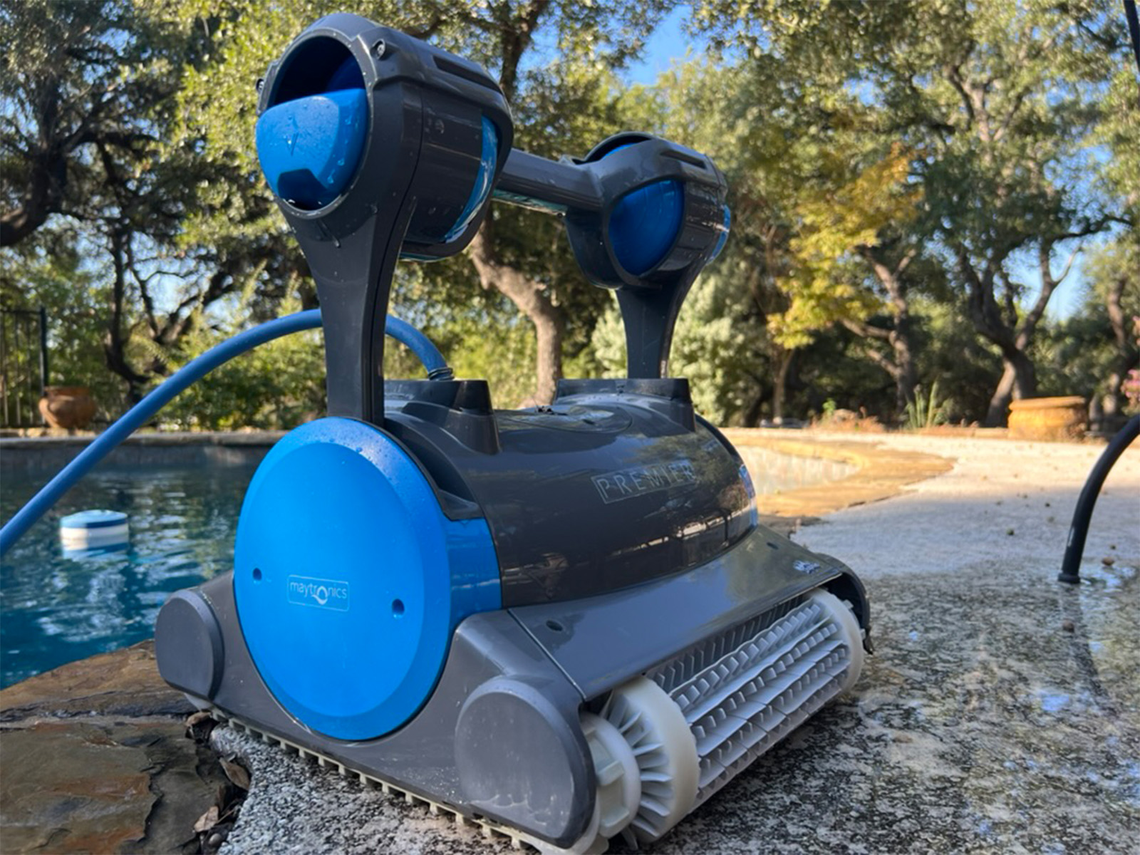 Side view of the Dolphin Premier showing the blue Maytronics side panel and rubber tracks