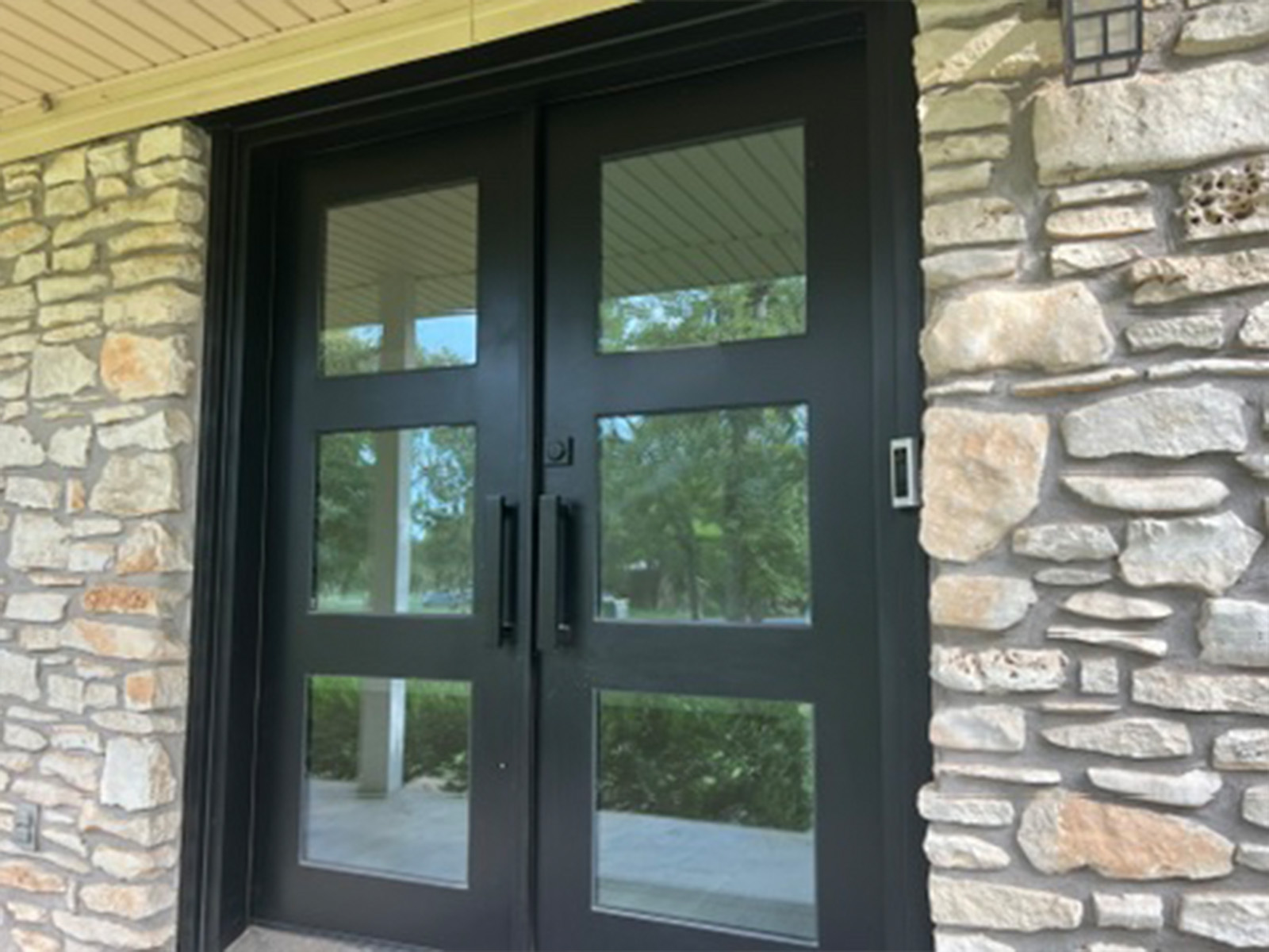 The wide view of the double front doors and stone facade the Ring Video Doorbell Pro watches over