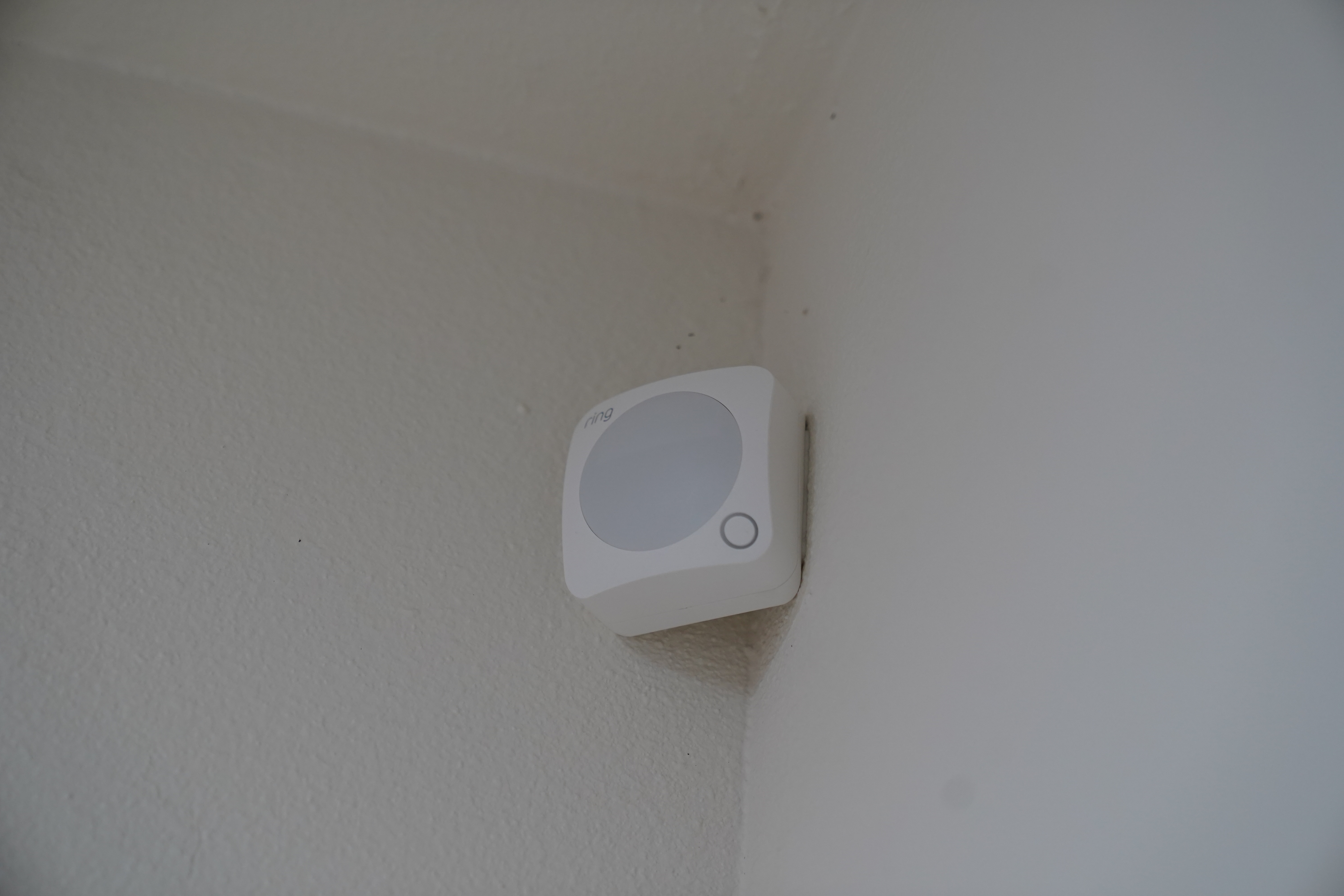 A Ring Alarm motion detector mounted in a room corner