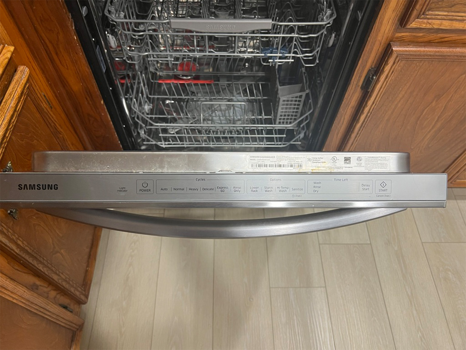 The Samsung StormWash control panel along the top edge of the door, with the full cycle and option layout