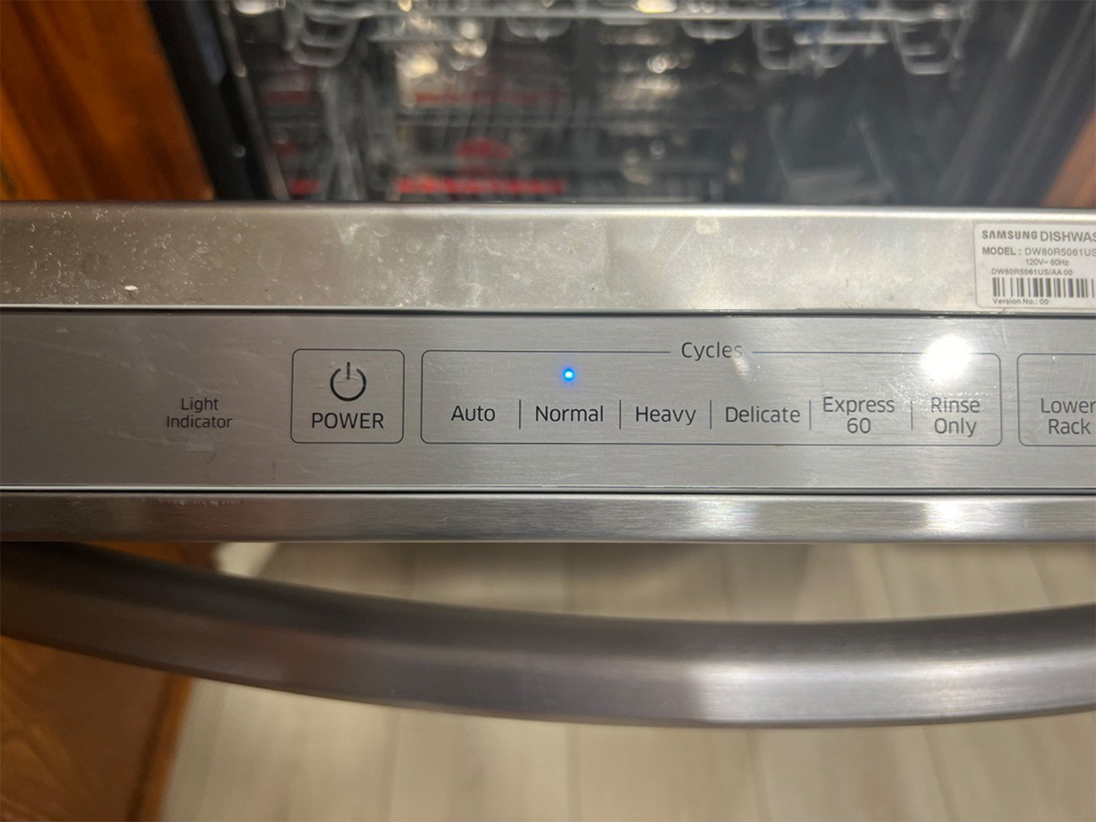 Close-up of the Samsung StormWash cycle selector showing Auto, Normal, Heavy, Delicate, Express 60, and Rinse Only