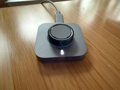 The compact Oura Ring 4 charger that lives on my desk for a quick weekly top-up