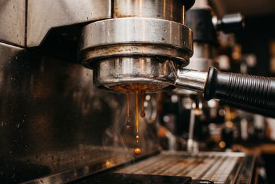 A portafilter locked into an espresso machine group head as a shot begins