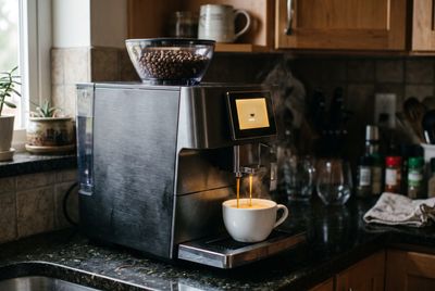 A fully automatic bean-to-cup espresso machine with a touchscreen
