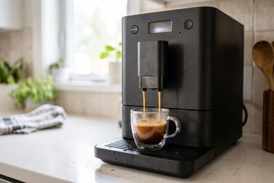 The Jura S8, a sleek super-automatic espresso machine, brewing a cup