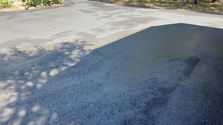 Freshly applied coating drying in dappled shade under the trees
