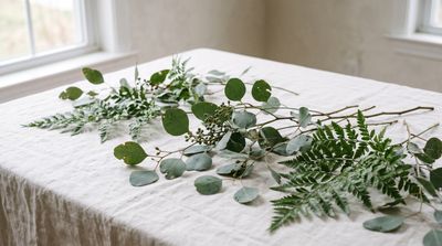 Green botanical branches on a neutral background