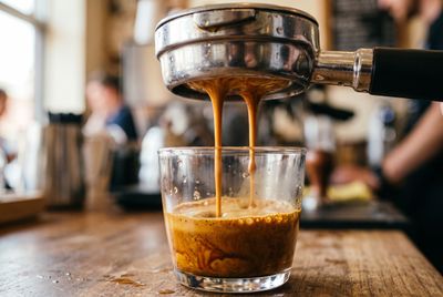 Espresso pouring from a bottomless portafilter with rich crema