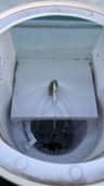 View into an open above-ground pool skimmer housing with the basket below