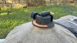Manual air relief valve on top of a pool filter tank