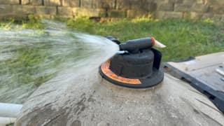 Water spraying in a steady stream from the open air relief valve on a pool filter
