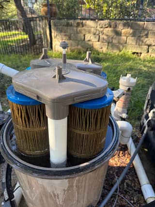 Open SwimClear filter tank showing the sealing lip and the cartridges below