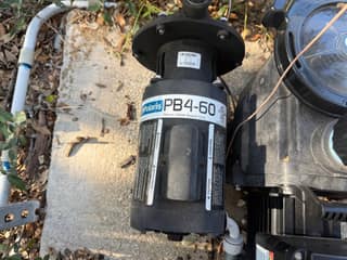 Top view of a Polaris PB4-60 booster pump beside the main pool pump