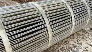 Rinsed pool filter cartridge lying on a stone ledge with clean light gray pleats