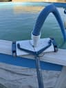Vacuum hose seated on the swivel fitting of a wheeled vinyl-safe head
