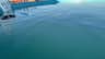 A water-filled vacuum hose floating toward the submerged head at the wall