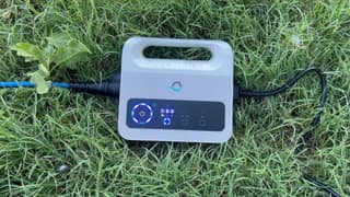The Dolphin Cayman power supply with its weekly timer controls lit on the grass