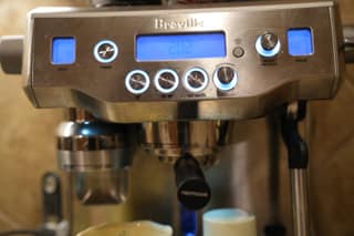 The Breville Oracle control panel viewed straight on with the labels readable