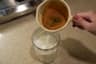 A finished double shot held in a cup