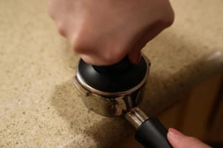 Pressing the tamper into the portafilter