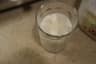 A glass of ice and milk viewed from above