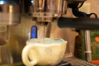 Cup on the scale under the locked-in portafilter, about to start