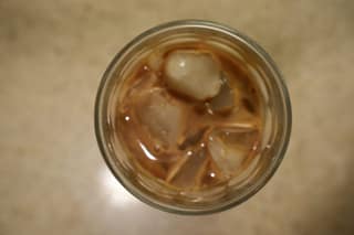 Top-down view of an iced latte with ice cubes