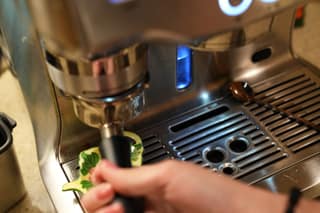Lifting the portafilter toward the grinder cradle