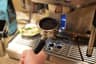 A spent espresso puck in the portafilter after the shot