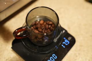 A cup of beans on the scale reading 17.9 grams
