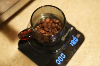 A cup of beans on the scale reading 18 grams