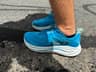 Side view of the Hoka Clifton 10's thick EVA midsole and rocker geometry