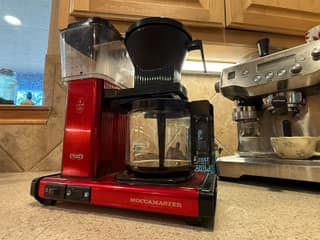 Side view of my Candy Apple Red Moccamaster KBGV Select beside an espresso machine