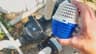 Holding the PoolRx+ unit above the open pool pump strainer housing