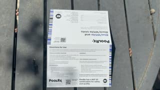 PoolRx+ directions-for-use insert laid out on a patio table