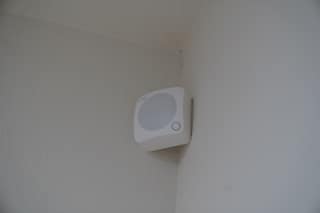 A Ring Alarm motion detector mounted in a room corner