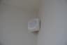 A Ring Alarm motion detector mounted in a room corner