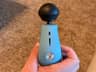 The USB-C port, speed lights, and power button on the Theragun Mini