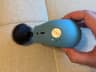 Theragun Mini side button with one blue battery light and three speed indicator positions