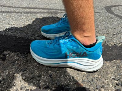 Side profile of the Hoka Clifton 10 showing the thick EVA midsole and rocker geometry